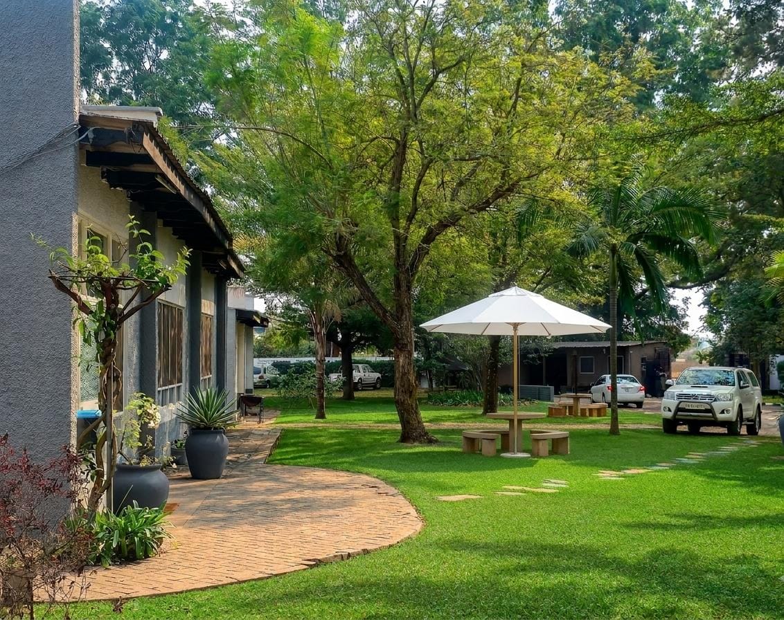Shaded garden seating area at Tau House